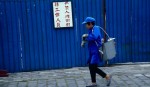 Woman Against Blue Wall