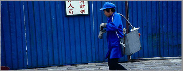 Woman Against Blue Wall, From the Odyssey Travel to China Photo Series. Learn More >